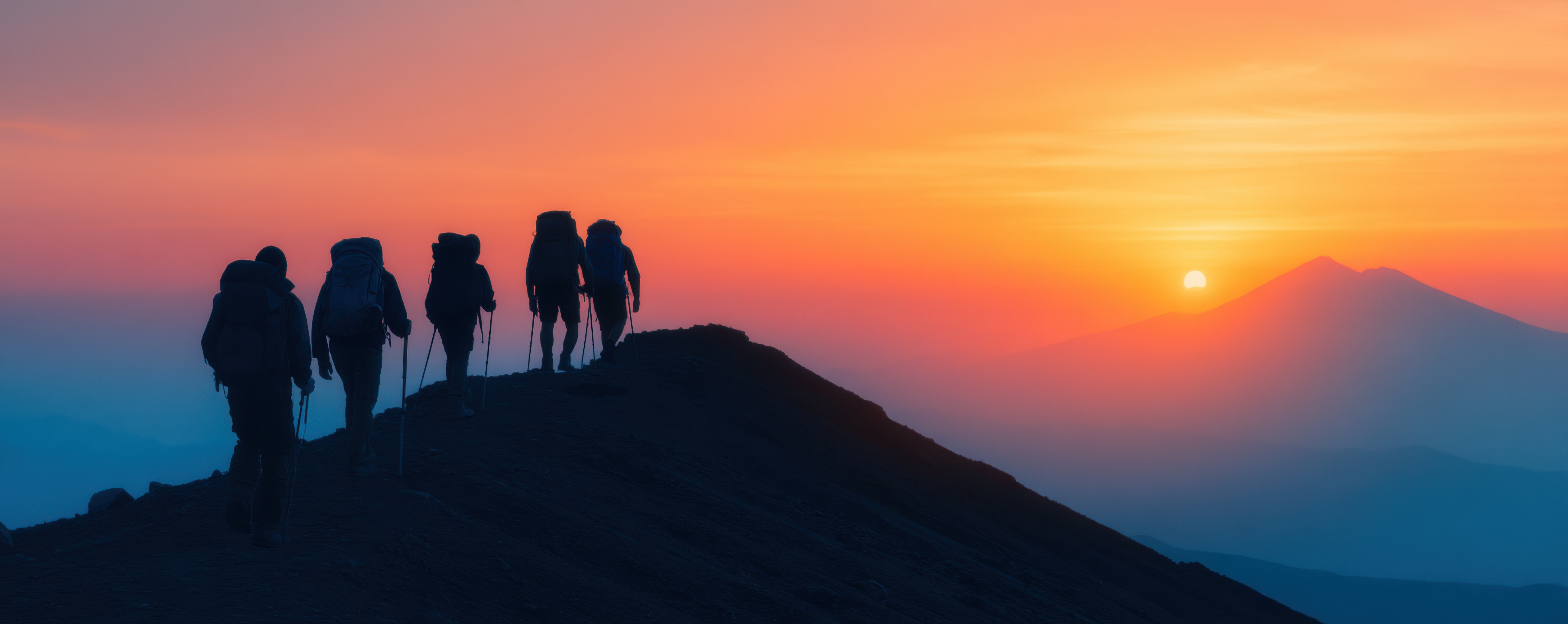 Golden mountain landscape at dusk — a group experience about to begin